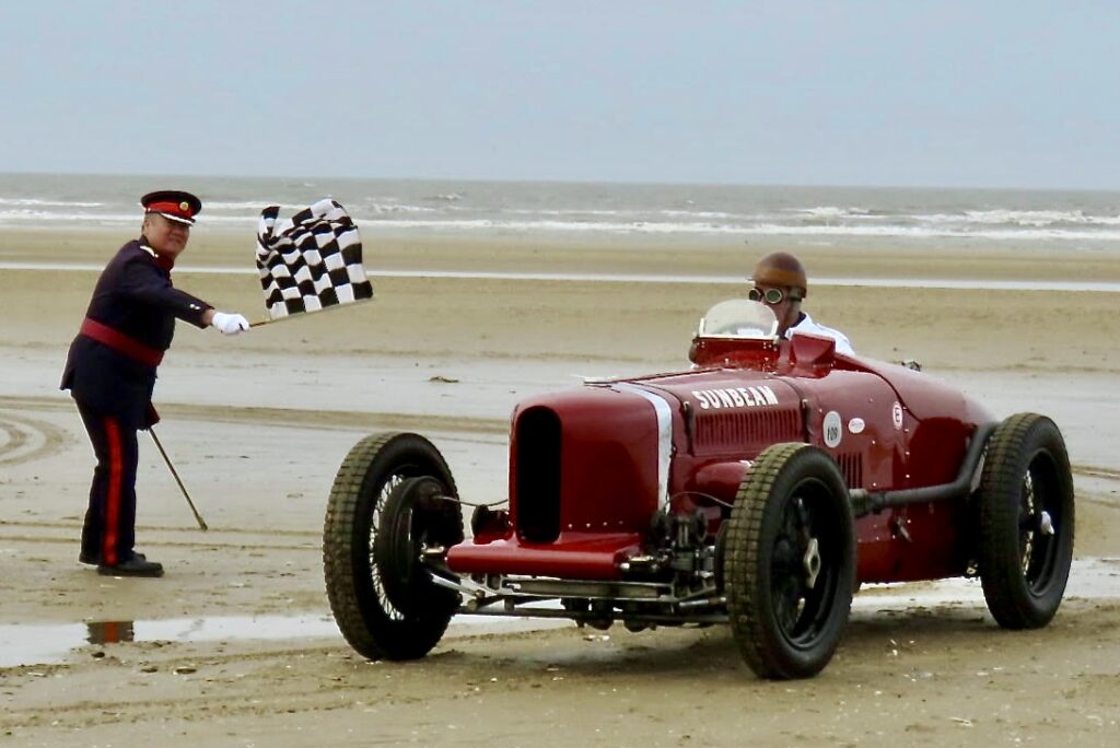 Crowds celebrated the return of the Sunbeam Tiger to Ainsdale Beach in Southport 100 years after it was driven by Sir Henry Segrave as he broke the world land speed record on 16th March 1926. The car was driven by Wing Commander Andy Green OBE as he was waved off by Merseyside High Sheriff Billy Hui BEM and Consort Kerry Beresford. Photo by Andrew Brown Stand Up For Southport